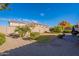 Landscaped backyard with grassy area and gravel at 16140 W Almeria Rd, Goodyear, AZ 85395