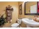 Well-appointed bathroom with pedestal sink and toilet at 16140 W Almeria Rd, Goodyear, AZ 85395