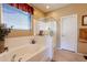 Bathroom featuring a bathtub, shower and ample storage at 16140 W Almeria Rd, Goodyear, AZ 85395