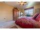 Comfortable bedroom with a queen bed and a large wardrobe at 16140 W Almeria Rd, Goodyear, AZ 85395