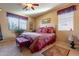 Bright bedroom with a queen-size bed and decorative pillows at 16140 W Almeria Rd, Goodyear, AZ 85395
