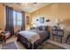 Cozy bedroom with a queen-size bed and decorative accents at 16140 W Almeria Rd, Goodyear, AZ 85395