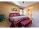 Bedroom with a queen bed, a sitting area and an ensuite bathroom at 16140 W Almeria Rd, Goodyear, AZ 85395