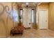 Spacious entryway with tile flooring and an ornate ottoman at 16140 W Almeria Rd, Goodyear, AZ 85395