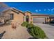 Tan colored house with a two-car garage and desert landscaping at 16140 W Almeria Rd, Goodyear, AZ 85395