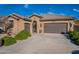 Single-story home with a two-car garage and landscaped front yard at 16140 W Almeria Rd, Goodyear, AZ 85395