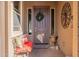 Inviting entryway with a bench, wreath, and decorative wall art at 16140 W Almeria Rd, Goodyear, AZ 85395