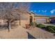 Landscaped front yard with gravel and decorative yard art at 16140 W Almeria Rd, Goodyear, AZ 85395