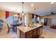 Island kitchen with granite countertops and breakfast bar seating at 16140 W Almeria Rd, Goodyear, AZ 85395