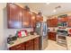 Kitchen with granite countertops, stainless steel appliances, and wood cabinets at 16140 W Almeria Rd, Goodyear, AZ 85395