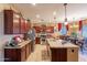 Open concept kitchen with granite countertops and island at 16140 W Almeria Rd, Goodyear, AZ 85395