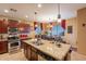 Island kitchen with granite countertops and stainless steel appliances at 16140 W Almeria Rd, Goodyear, AZ 85395
