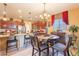 Eat-in kitchen with granite counters, dark wood cabinets, and an island at 16140 W Almeria Rd, Goodyear, AZ 85395