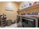 Laundry room with washer, dryer, and storage at 16140 W Almeria Rd, Goodyear, AZ 85395