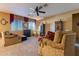 Bright living room with comfortable seating and a fireplace at 16140 W Almeria Rd, Goodyear, AZ 85395