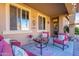 Covered patio with comfortable seating and a small table at 16140 W Almeria Rd, Goodyear, AZ 85395