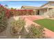 Landscaped backyard with patio and artificial turf at 16530 N 114Th Dr, Surprise, AZ 85378