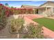 Landscaped backyard with patio and artificial turf at 16530 N 114Th Dr, Surprise, AZ 85378