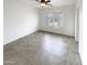 Bright bedroom with tile flooring and a window with plantation shutters at 16530 N 114Th Dr, Surprise, AZ 85378