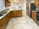 Kitchen with granite countertops, wooden cabinets, and stainless steel appliances at 16530 N 114Th Dr, Surprise, AZ 85378