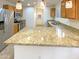 Island kitchen with granite countertops and stainless steel appliances at 16530 N 114Th Dr, Surprise, AZ 85378