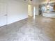 Open concept living area with tile flooring and a view of the kitchen at 16530 N 114Th Dr, Surprise, AZ 85378