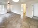 Bright living room with tile flooring, ceiling fan, and white plantation shutters at 16530 N 114Th Dr, Surprise, AZ 85378