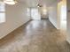 Open living room with tile floor and view of kitchen and hallway at 16530 N 114Th Dr, Surprise, AZ 85378