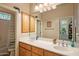 Bathroom with double sinks, wood cabinets, and a shower at 22719 N 93Rd St, Scottsdale, AZ 85255