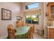 Bright dining area with wood table and chairs, offering a view of the backyard at 22719 N 93Rd St, Scottsdale, AZ 85255