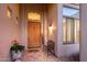 Inviting entryway with a wooden door, tile flooring, and a bench at 22719 N 93Rd St, Scottsdale, AZ 85255