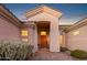 Elegant entryway with a wooden door and a brick walkway at 22719 N 93Rd St, Scottsdale, AZ 85255