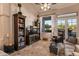 Comfortable living room featuring built-in shelving and backyard access at 22719 N 93Rd St, Scottsdale, AZ 85255