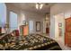 Main bedroom with large bed, dresser, and access to the bathroom at 22719 N 93Rd St, Scottsdale, AZ 85255
