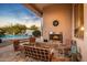 Outdoor patio with fireplace, seating, and pool view at 22719 N 93Rd St, Scottsdale, AZ 85255