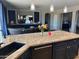 Island kitchen features granite countertops and dark cabinetry at 22834 E Mccowan Ct, Queen Creek, AZ 85142