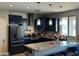 Modern kitchen with dark cabinets, granite counters and island at 22834 E Mccowan Ct, Queen Creek, AZ 85142