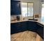 Modern kitchen with dark cabinetry, granite counters, and stainless steel appliances at 22834 E Mccowan Ct, Queen Creek, AZ 85142