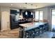 Modern kitchen with dark cabinets, granite counters, and island at 22834 E Mccowan Ct, Queen Creek, AZ 85142