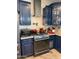 Modern gas range with dark blue cabinets at 22834 E Mccowan Ct, Queen Creek, AZ 85142