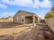 Covered patio and gravel backyard with block wall at 41096 W Jenna Ln, Maricopa, AZ 85138