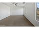 Large bedroom with plush carpeting and ceiling fan at 41096 W Jenna Ln, Maricopa, AZ 85138