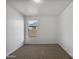 Bright bedroom with carpet and large window at 41096 W Jenna Ln, Maricopa, AZ 85138