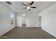 Spacious bedroom with carpet, ceiling fan and ensuite bathroom at 41096 W Jenna Ln, Maricopa, AZ 85138