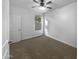 Well-lit bedroom with carpet and ceiling fan at 41096 W Jenna Ln, Maricopa, AZ 85138