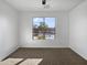 Bright bedroom featuring carpet and a large window at 41096 W Jenna Ln, Maricopa, AZ 85138