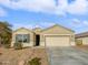 Tan house with two-car garage and desert landscaping at 41096 W Jenna Ln, Maricopa, AZ 85138