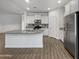Modern kitchen island with granite countertop and white cabinetry at 41096 W Jenna Ln, Maricopa, AZ 85138