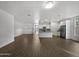 Spacious living room with wood-look floors and kitchen access at 41096 W Jenna Ln, Maricopa, AZ 85138