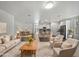 Open living area with beige couch and kitchen views at 41096 W Jenna Ln, Maricopa, AZ 85138